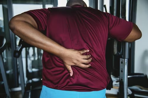 Person with back pain - 5 Signs You Need a Chiropractor in Peoria IL