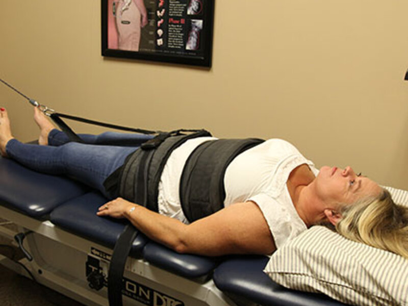 Patient receiving spinal decompression therapy on DRS table at Absolute Wellness Chiropractic Peoria IL